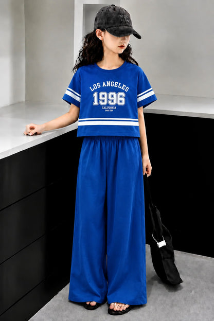 Blue girls’ Los Angeles 1996 graphic co-Ord set with wide-leg pants, stylish summer outfit for kids in Pakistan.
