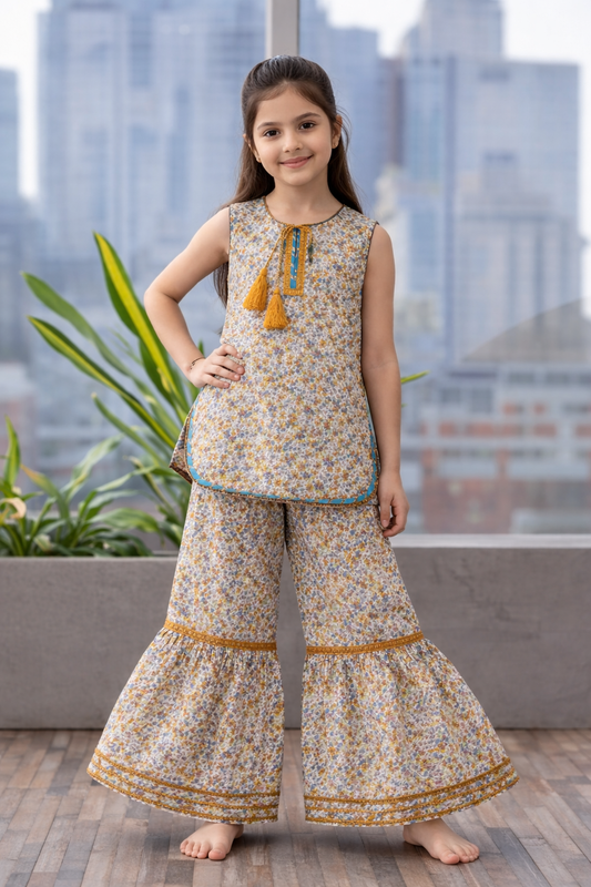 Beige floral cotton sharara suit for girls with tassel kurti and flared pants, balcony setting Pakistan
