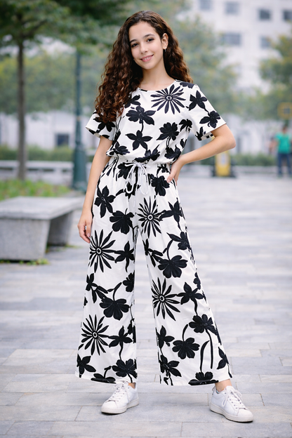 Teen girls white cotton co-ord set with black floral print, short sleeve top and wide-leg trousers, Pakistan
