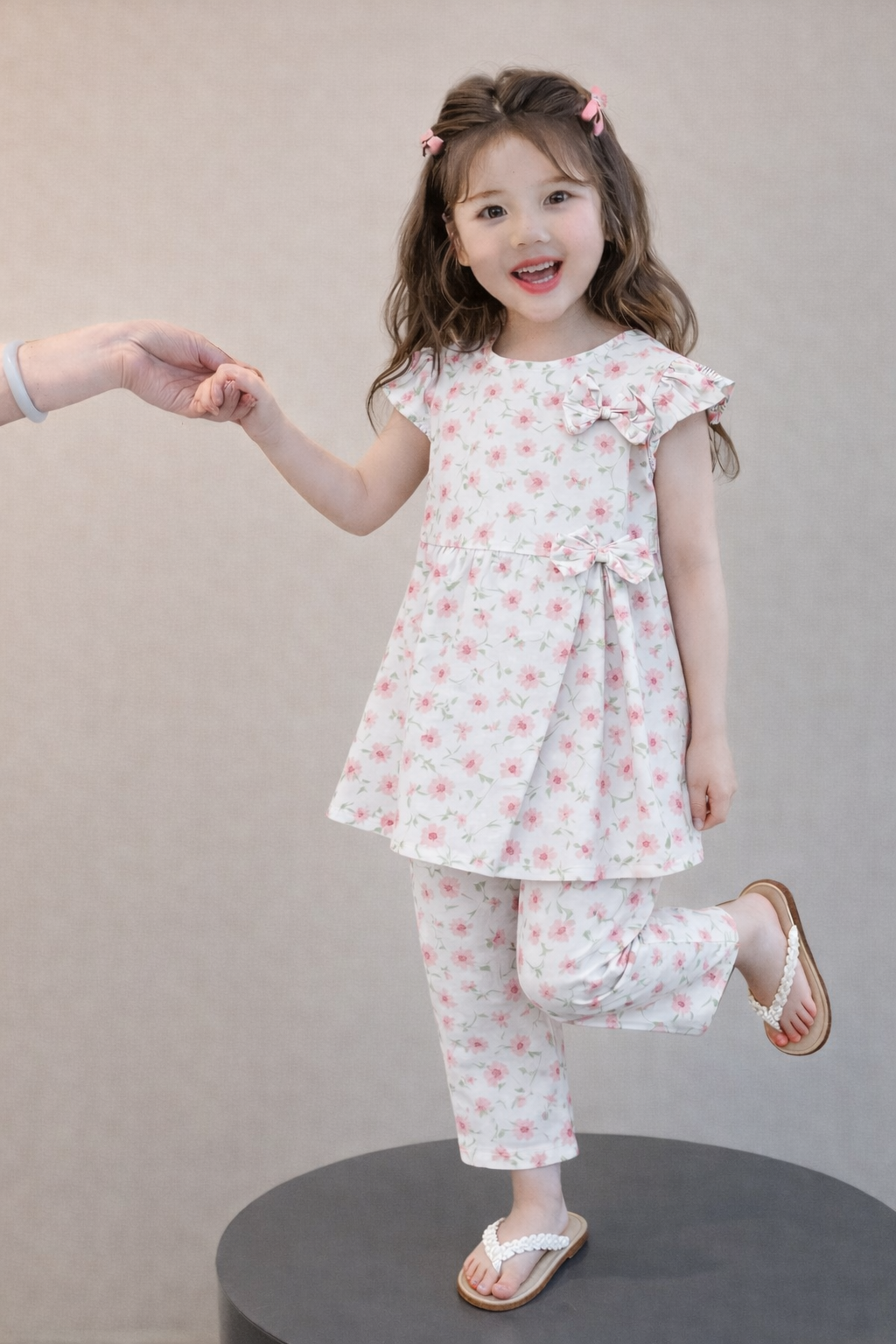 Cream floral cotton girls co-ord set with bow detail indoor.