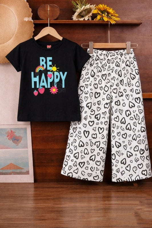 Black cotton girls co-ord set with “Be Happy” print short sleeve T-shirt and white heart print wide-leg pants,Pakistan
