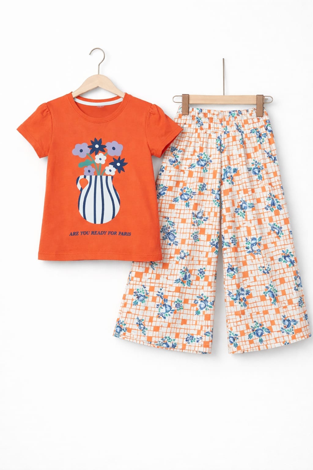 Orange girls co-ord set with flower vase print short sleeve T-shirt and floral wide-leg pants, Pakistan

