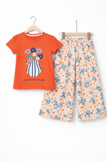 Orange girls co-ord set with flower vase print short sleeve T-shirt and floral wide-leg pants, Pakistan
