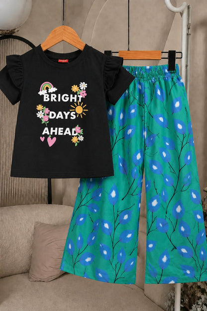 Girls black “Bright Days Ahead” printed cotton t-shirt with green leaf print wide leg trousers co-ord set for kids, stylish summer outfit in Pakistan.
