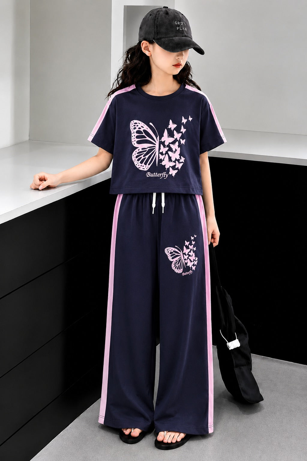 Navy blue girls butterfly print co-ord set with crop t-shirt and wide leg trousers in Pakistan.

