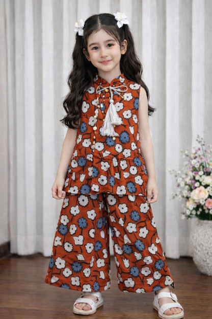 Rust orange floral cotton girls co-ord set with tassel top indoor.