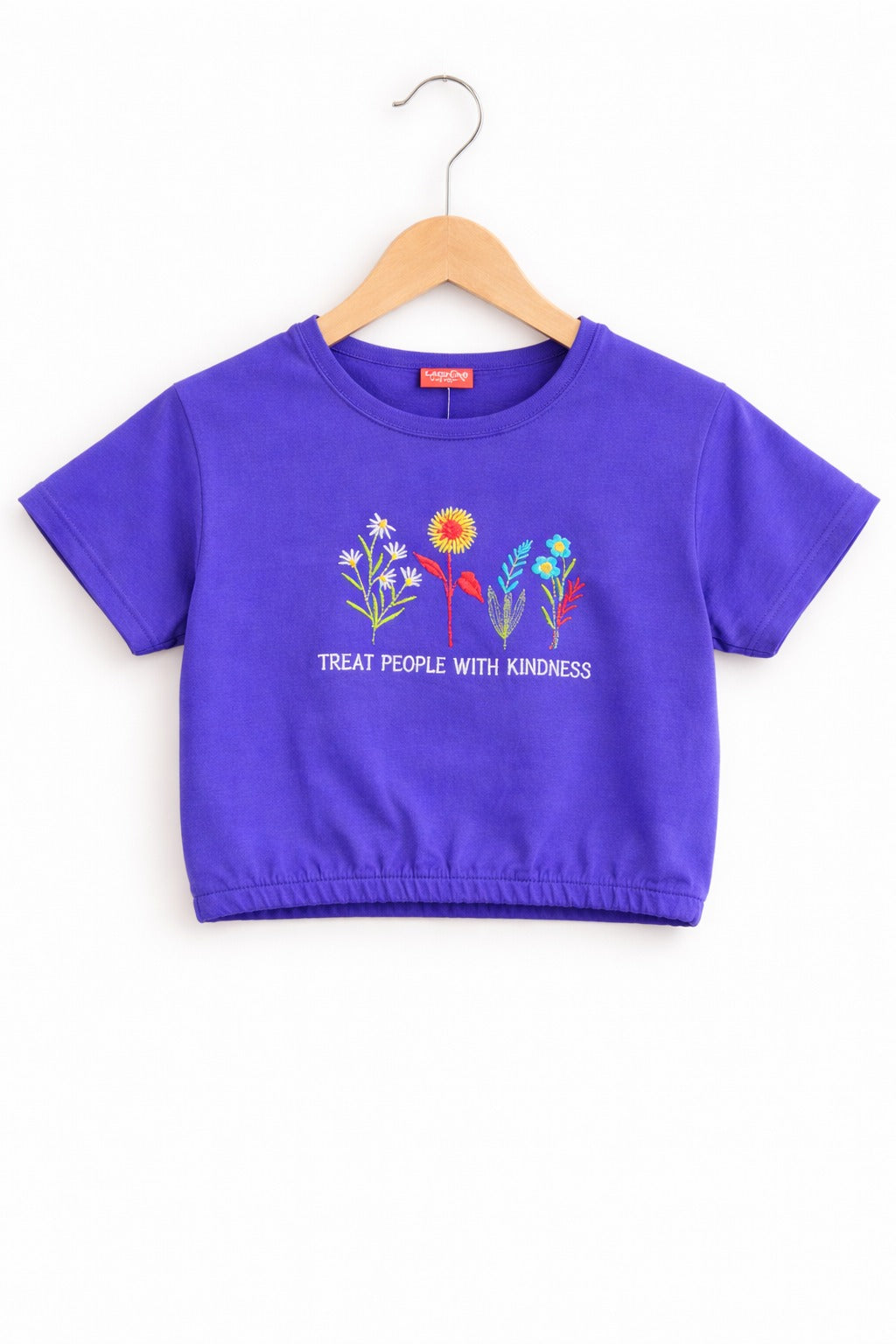 Girls purple cotton crop t-shirt with colorful floral embroidery and “Treat People With Kindness” text, Pakistan casual summer Kidswear
