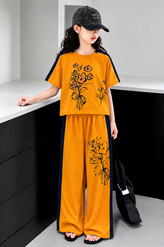 Mustard yellow girls’ floral print co-ord set with contrast side panels and wide-leg pants, stylish summer outfit for kids in Pakistan.
