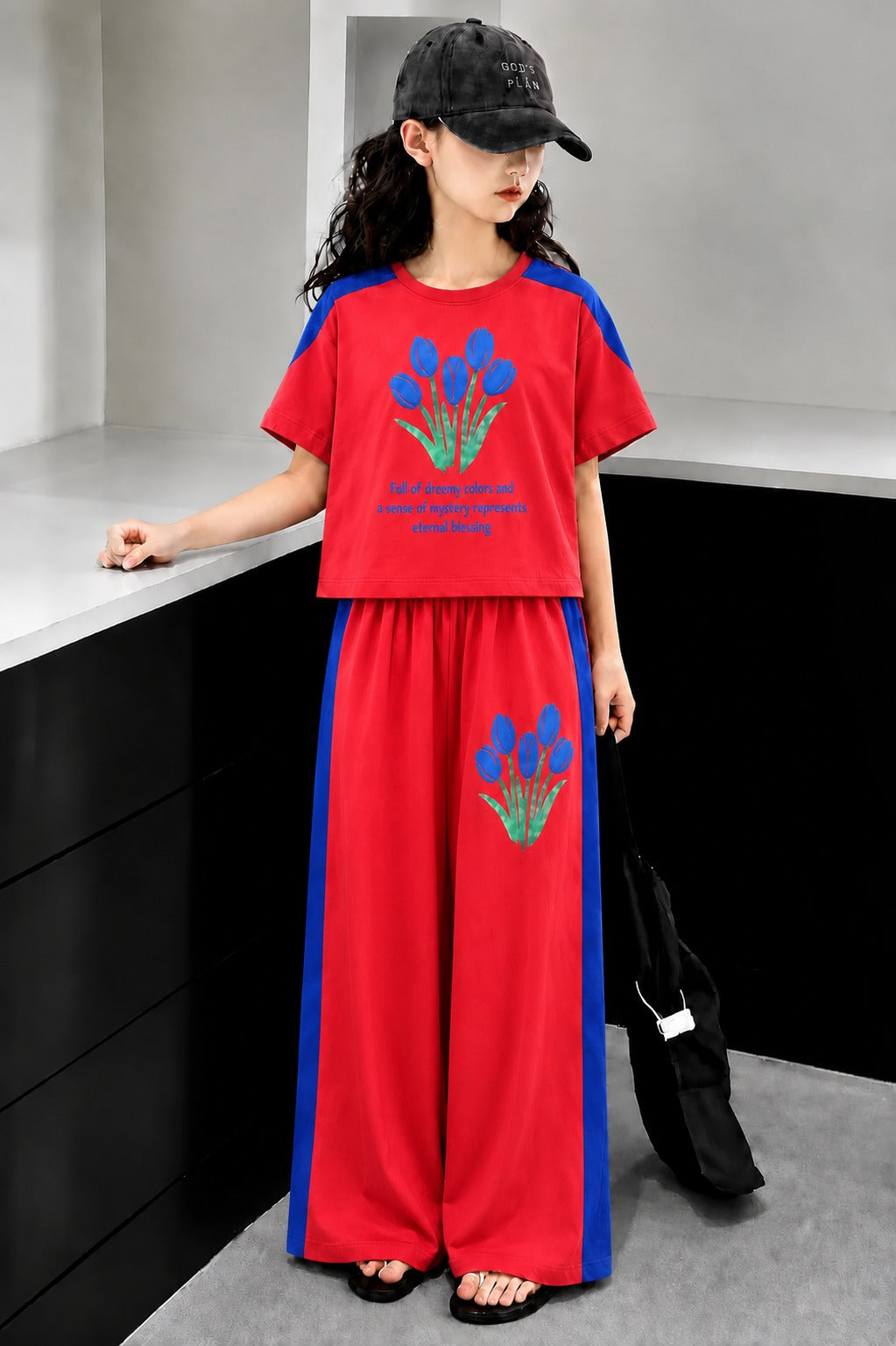 Red girls’ floral print co-Ord set with contrast sleeves and wide-leg pants.
