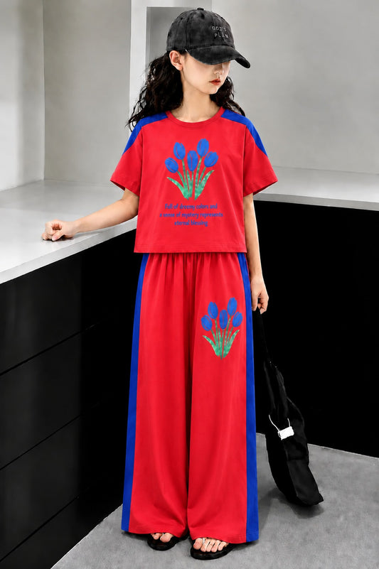 Red girls’ floral print co-Ord set with contrast sleeves and wide-leg pants.
