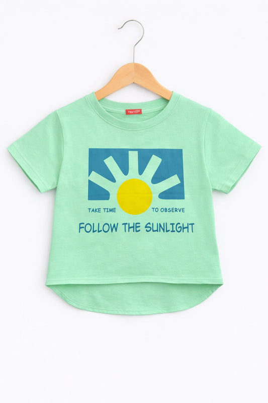 Girls light green cotton t-shirt with sunshine graphic and “Follow The Sunlight” text print, Pakistan casual summer Kidswear 