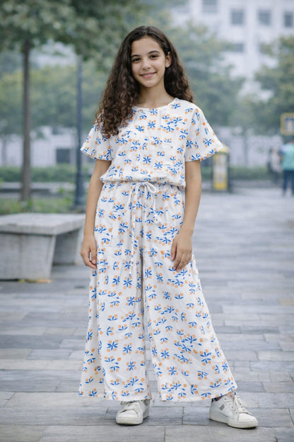 White cotton girls co-ord set with blue and orange floral print, short sleeve top and wide-leg pants,  Pakistan
