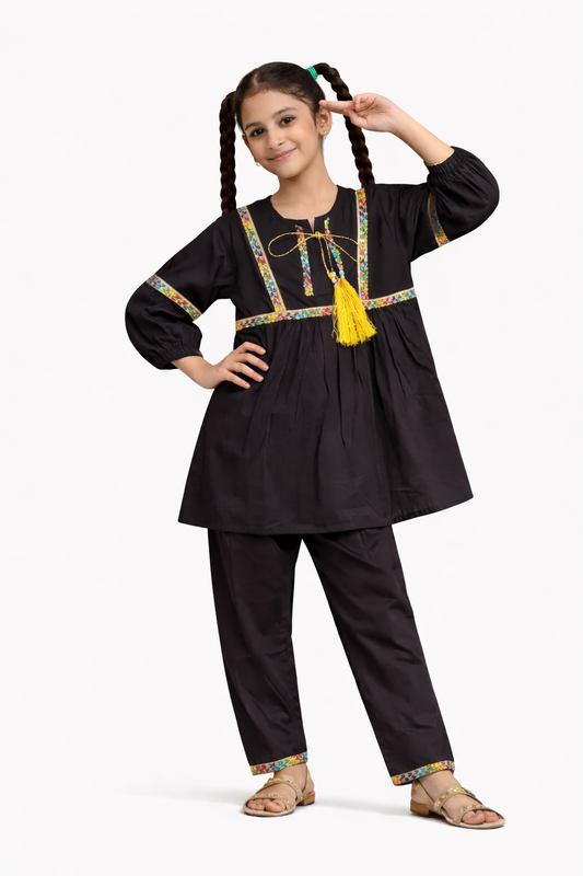Black cotton 2-piece outfit for girls with tassel detail kurti and straight pants, studio background Pakistan
