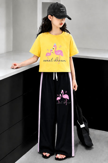 Mustard yellow girls flamingo print co-ord set with crop t-shirt and black wide leg trousers in Pakistan.
