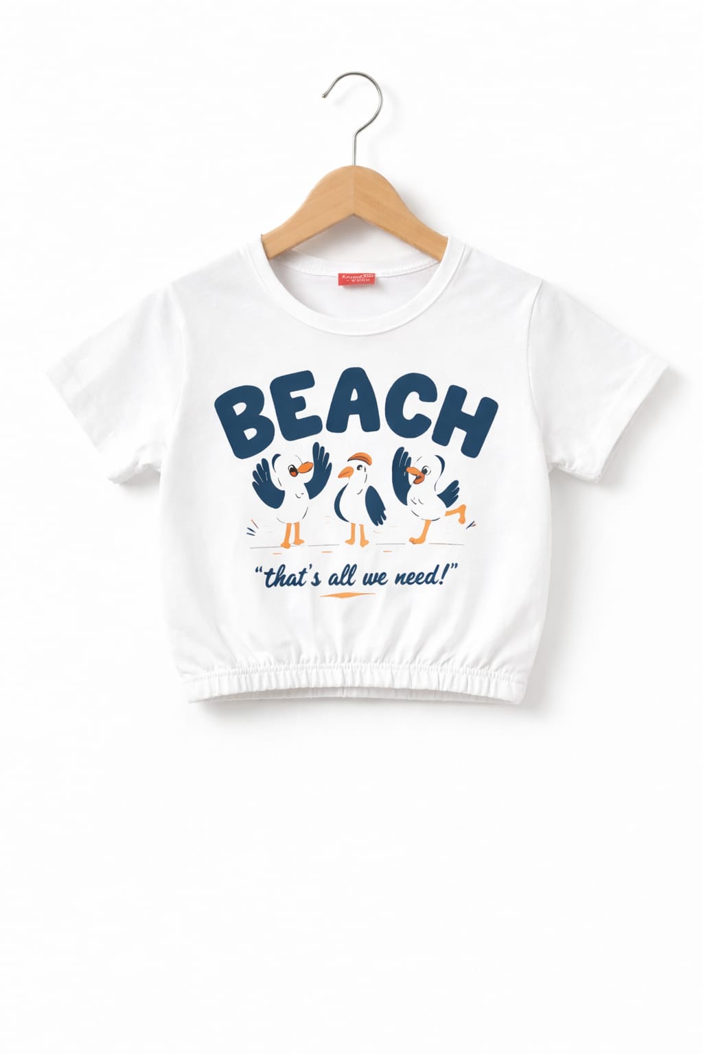 White girls crop t-shirt with “Beach That’s All We Need” bird graphic print and elastic hem design in Pakistan.
