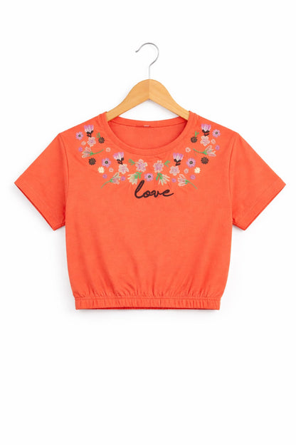 Coral girls crop t-shirt with floral embroidery style “Love” print and elastic hem design in Pakistan.
