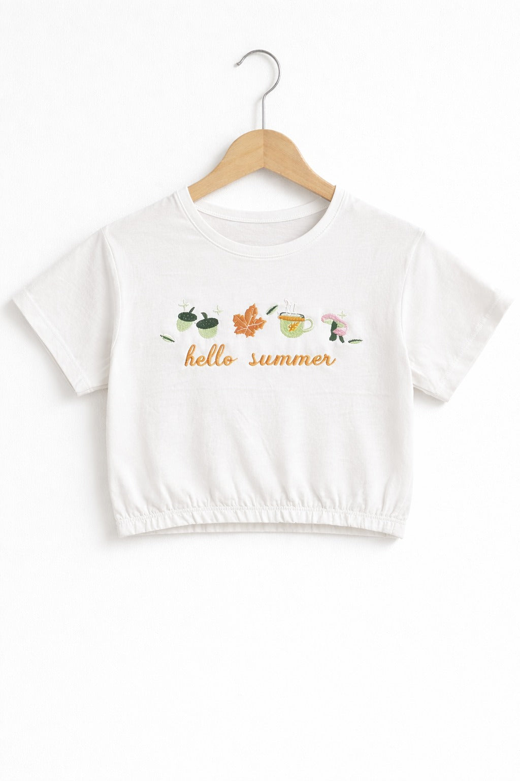 White girls crop t-shirt with “Hello Summer” graphic print and elastic hem design in Pakistan.
