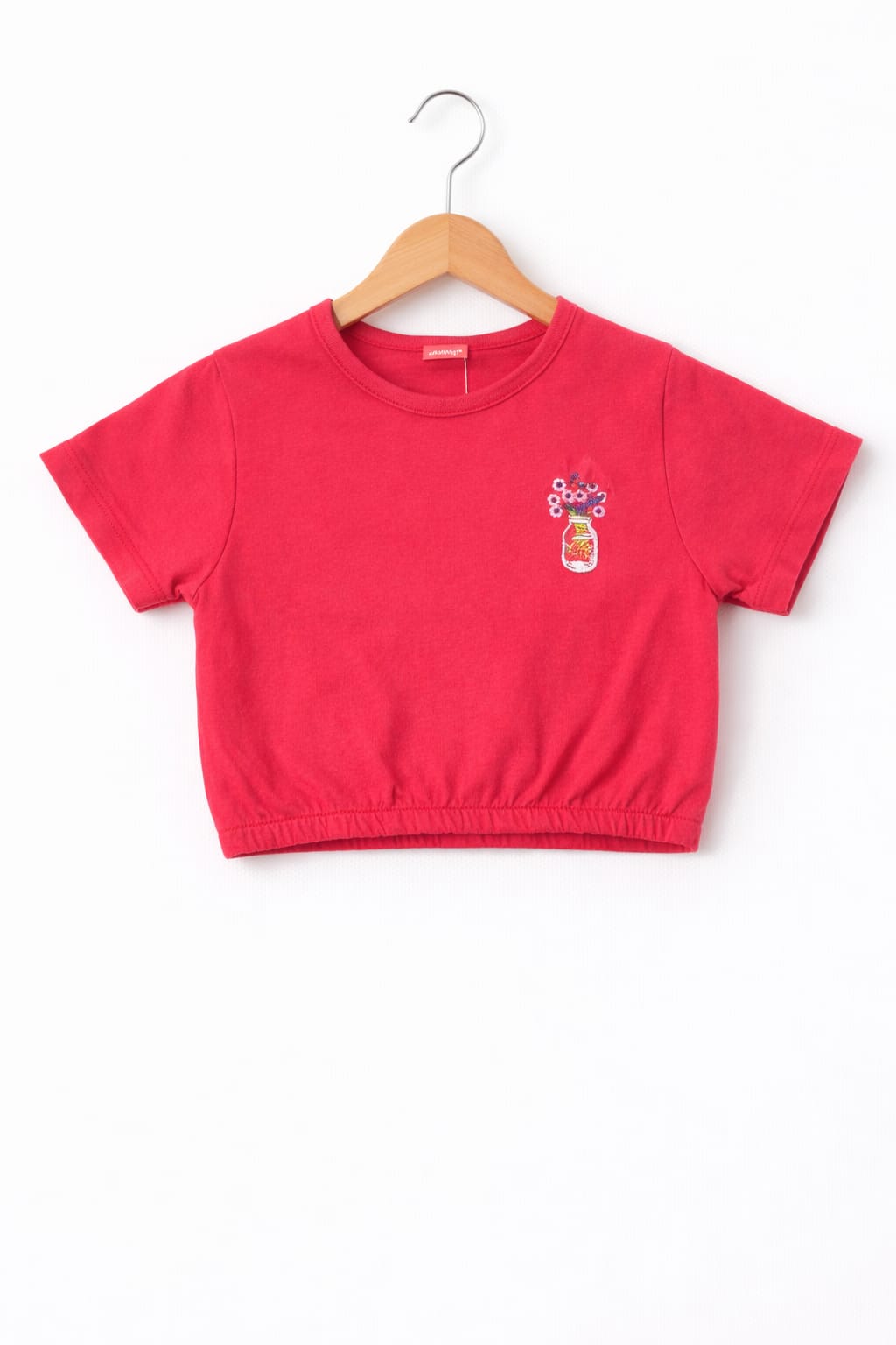 Pink girls crop t-shirt with small floral jar print and elastic hem design in Pakistan.
