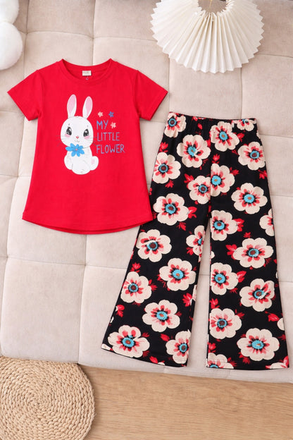 Red bunny print cotton t-shirt with black floral pants girls outfit flat lay.