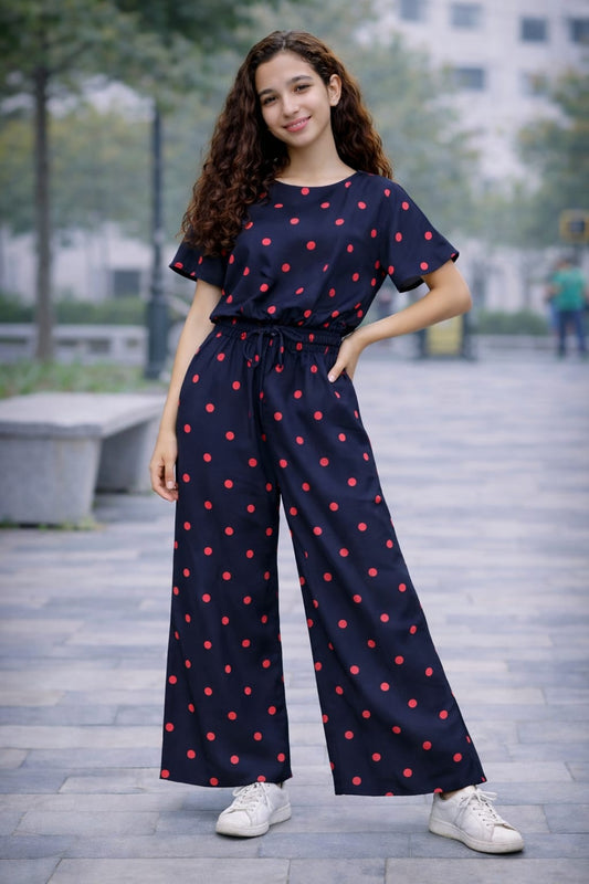 Navy blue cotton girls co-ord set with red polka dot print, short sleeve top and wide-leg pants, casual outdoor street style Pakistan
