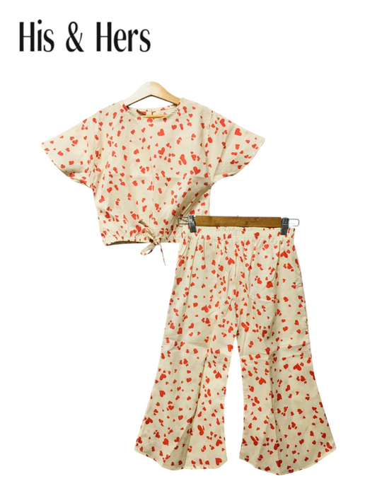 Off-white cotton girls co-ord set with red heart print, short sleeve top and flared pants, Pakistan

