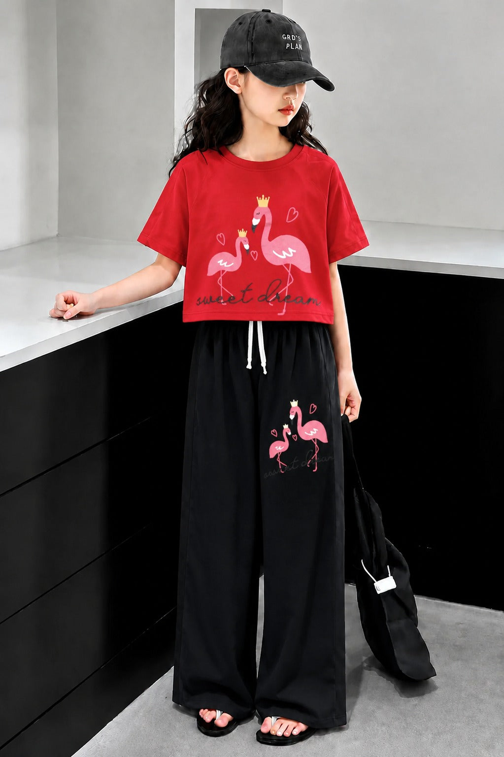 Red girls flamingo print co-ord set with crop t-shirt and black wide leg trousers in Pakistan.
