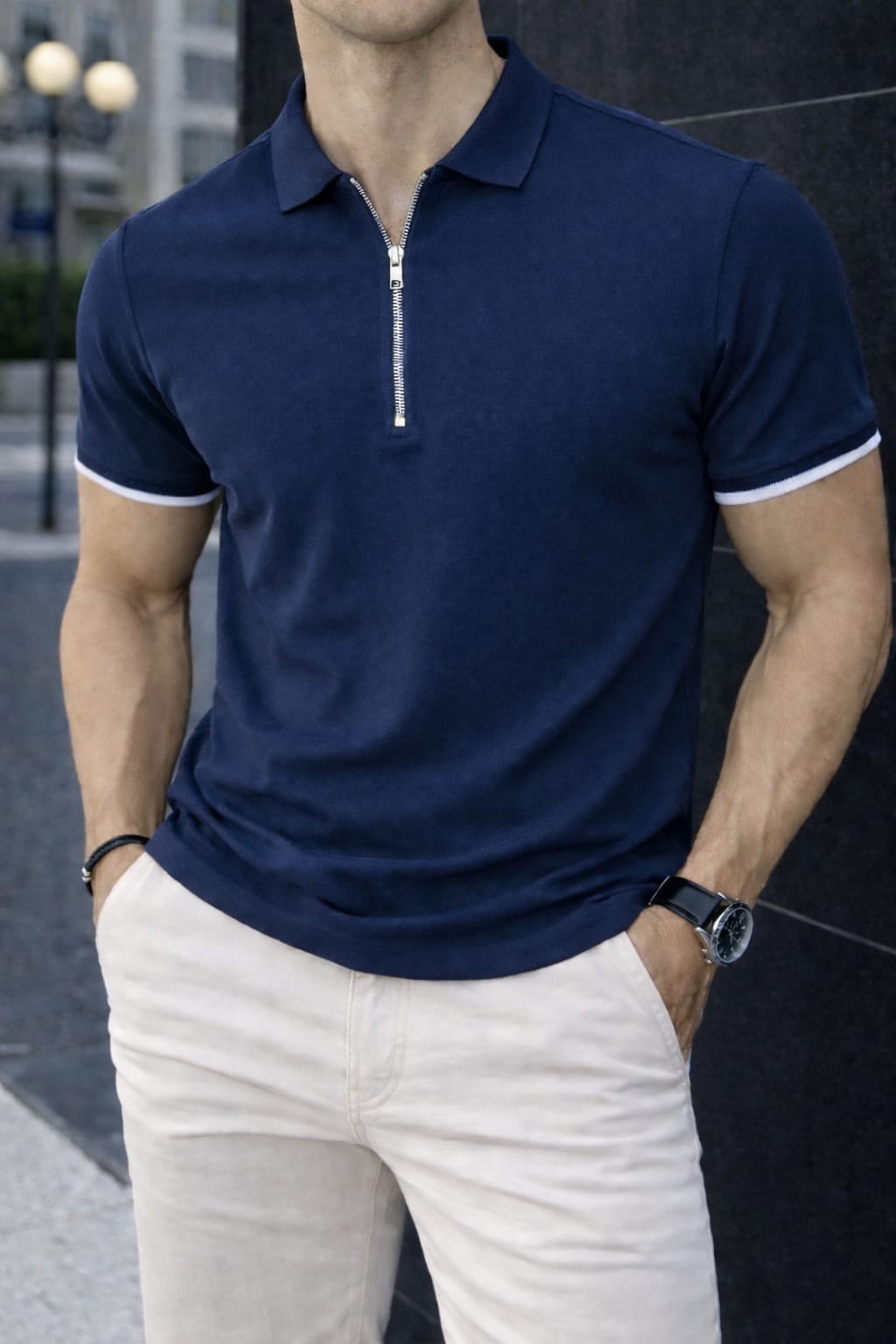 Smart casual navy blue polo shirt for men paired with light trousers.