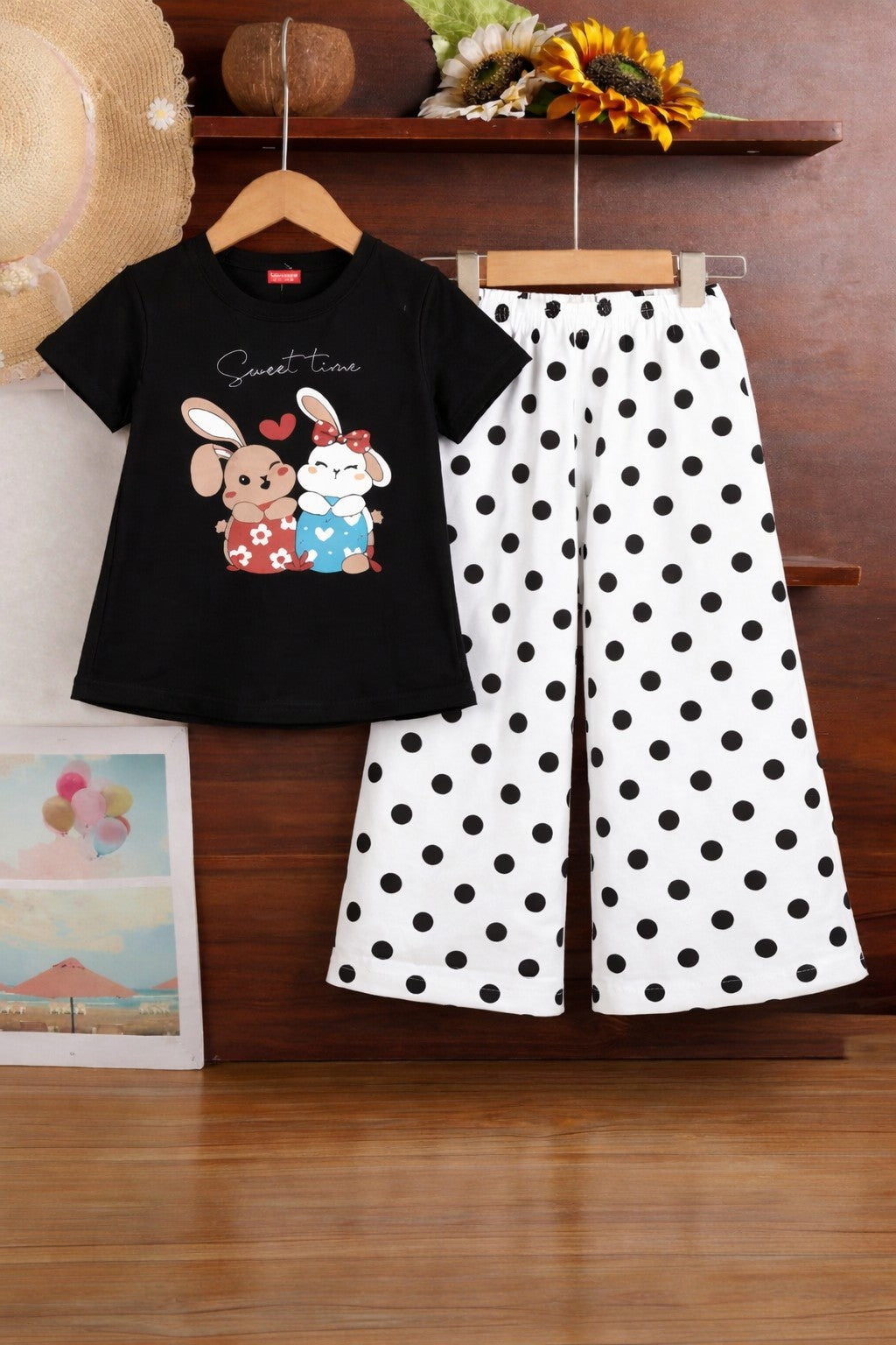 Black cotton girls co-ord set with short sleeve rabbit print t-shirt and white polka dot wide-leg pants, kids outfit Pakistan.
