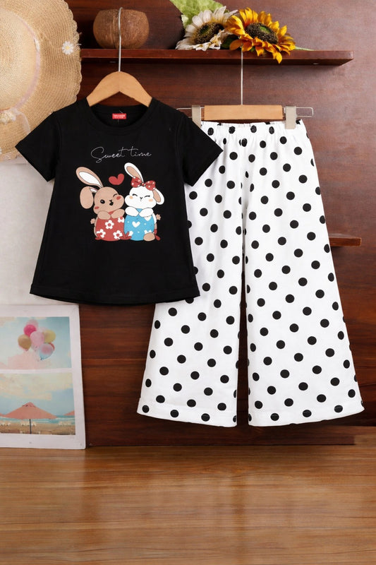 Black cotton girls co-ord set with short sleeve rabbit print t-shirt and white polka dot wide-leg pants, kids outfit Pakistan.
