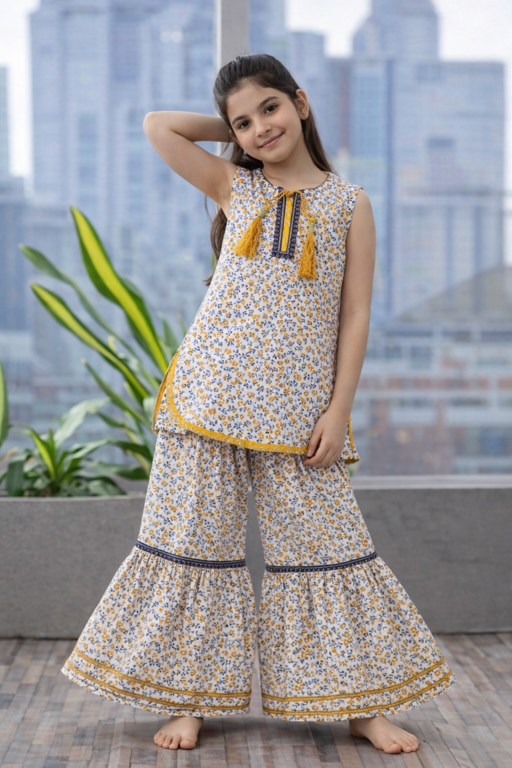 Girls mustard floral sharara suit in imported cotton with sleeveless kurti and ruffle sharara pants